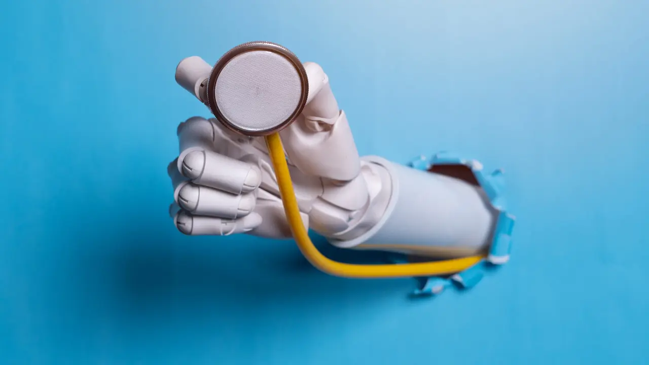 A robotic arm bust through a blue wall while holding a medical stethoscope.