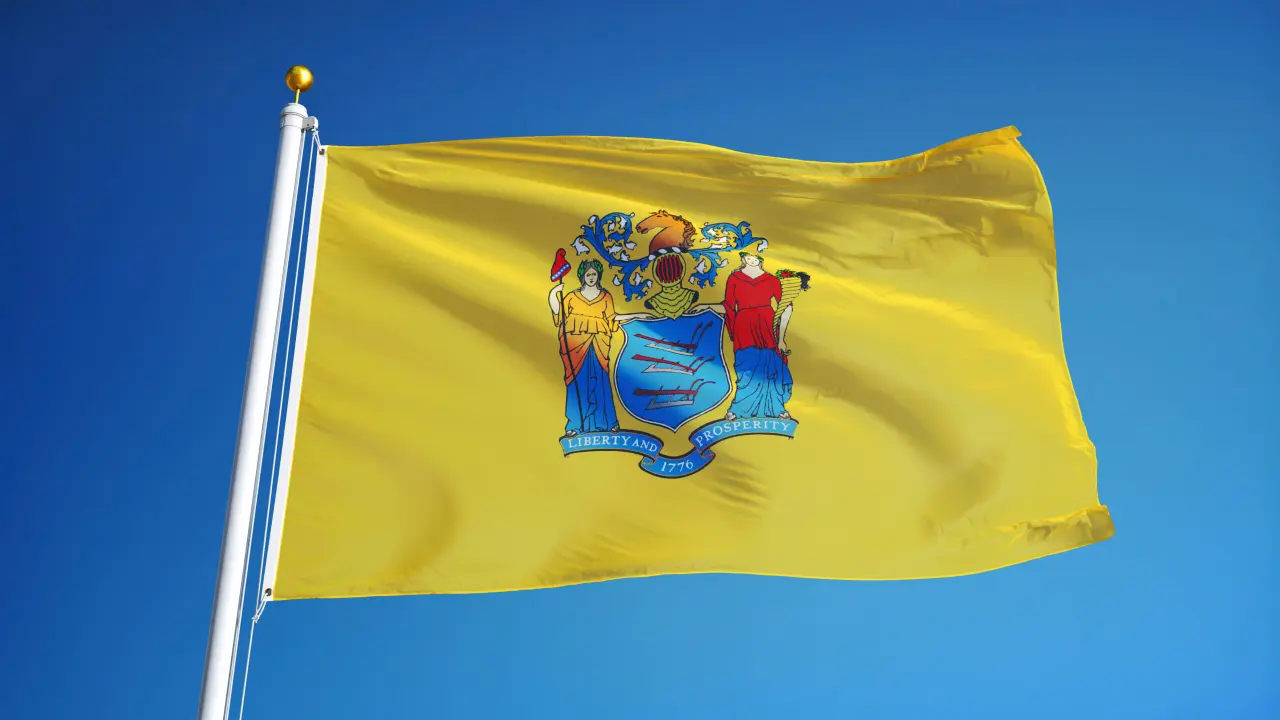 new,jersey,(u.s.,state),flag,waving,against,clear,blue,sky,