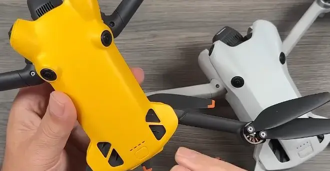 Two drones, one yellow, one grey, almost identical otherwise.