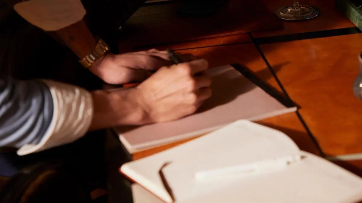 A lawyer editing a contract while going through a contract review checklist.